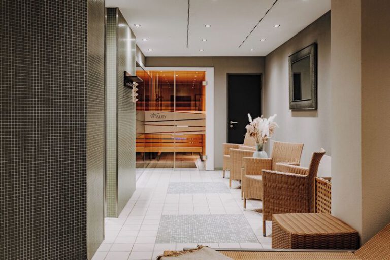 Entspannungsbereich mit gemütlichen Sitzmöbeln und direktem Zugang zur Sauna – perfekt für ruhige Momente im Hotel